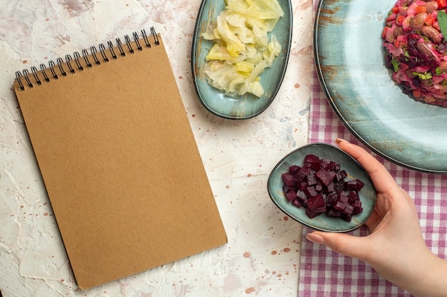 Hands holding recipe notebook